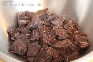 Chunks of caterer's dark chocolate in a steel bowl