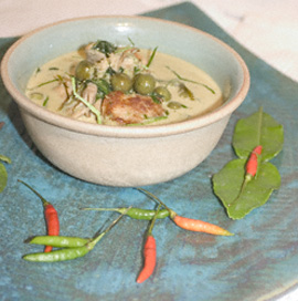 A bowl of Thai green curry with pork