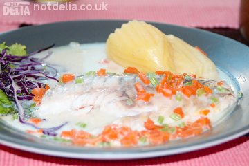 Seabass in a watery white wine sauce with boiled potatoes