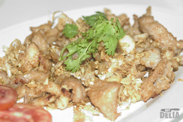 A plate of fried pork with garlic