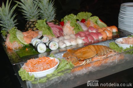 A display of assorted sushi on ice at a hotel buffet